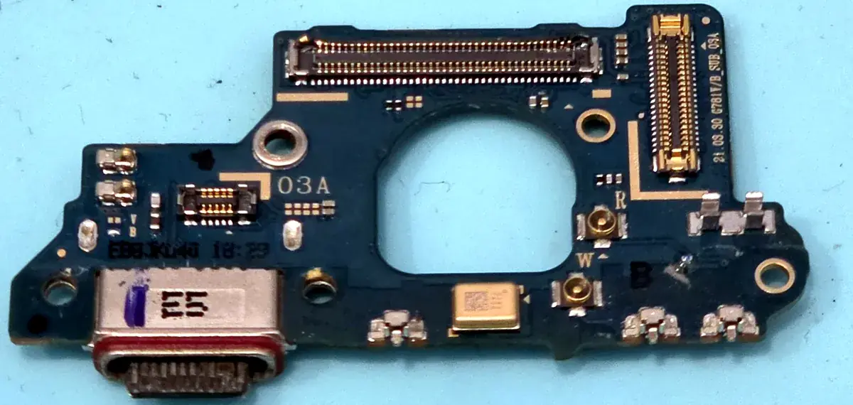 Damaged USB-C charging port board removed from a Samsung Galaxy S20 FE during a charging port repair